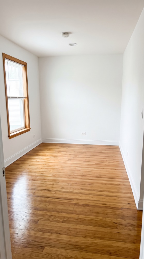 The same empty room after move-out cleaning, spotless floor