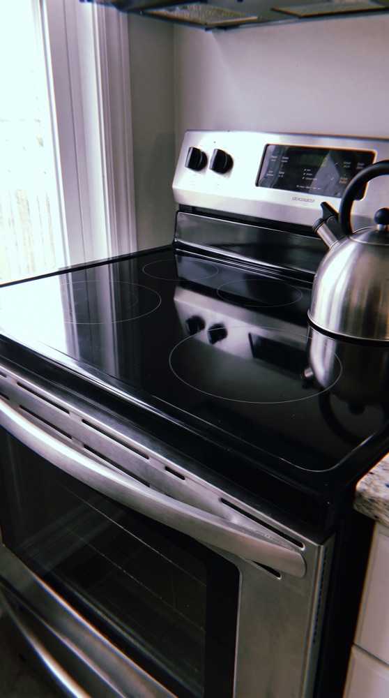 The same stovetop after cleaning, gleaming and grease-free